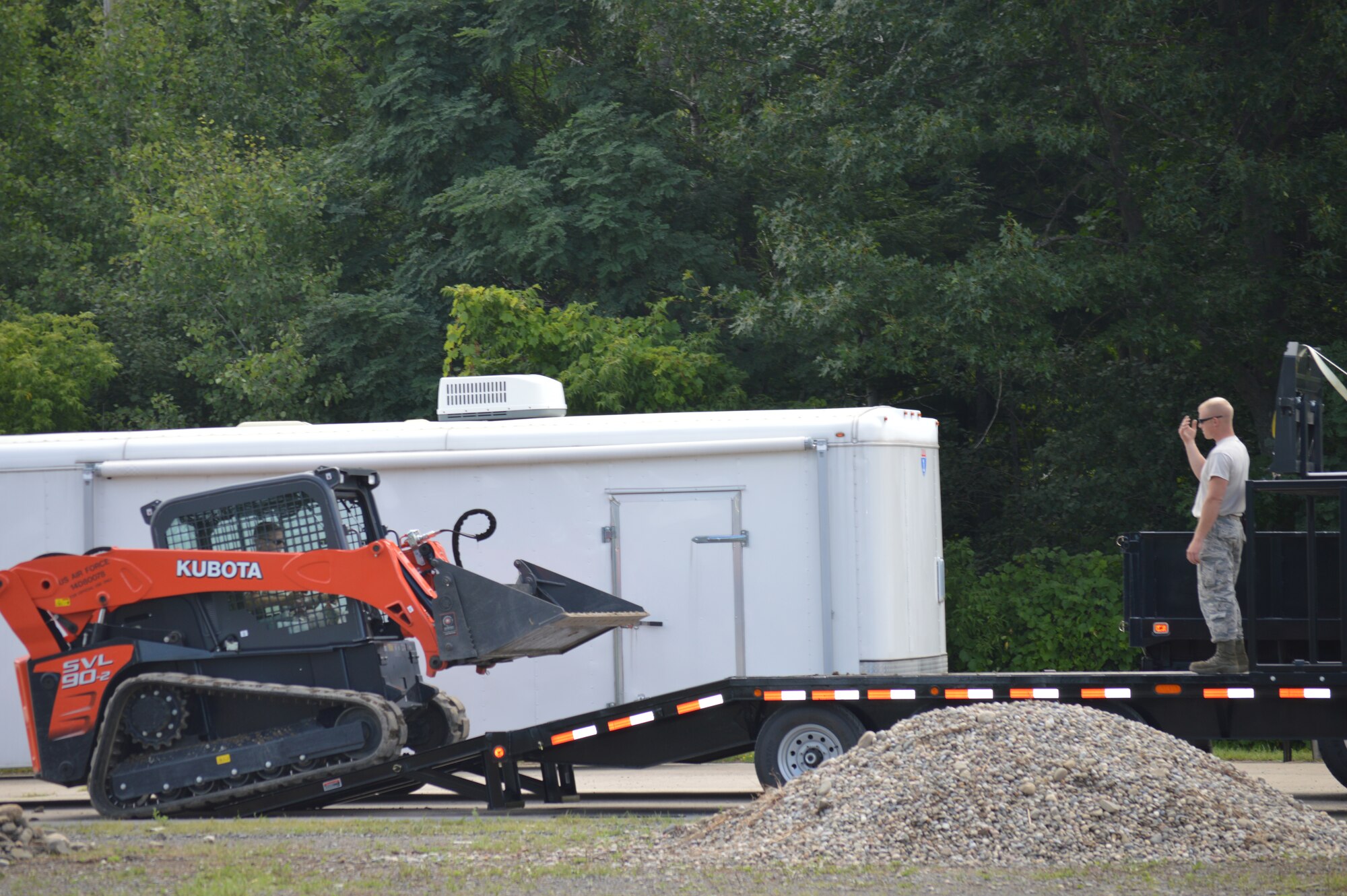 Tech. Sgt. Michael Eldred instructs a firefighter with the 109th Airlift Wing on how to operate a skid steer Aug. 12, 2015 at Stratton Air National Guard Base, New  York. The skid steers are part of the equipment package the 109th AW received as part of the debris clearance package to support domestic operations. The 109th Logistic Readiness Squadron's Vehicle Maintenance Flight has been training members throughout the base on the equipment received. (U.S. Air National Guard photo by Tech. Sgt. Catharine Schmidt/Released)