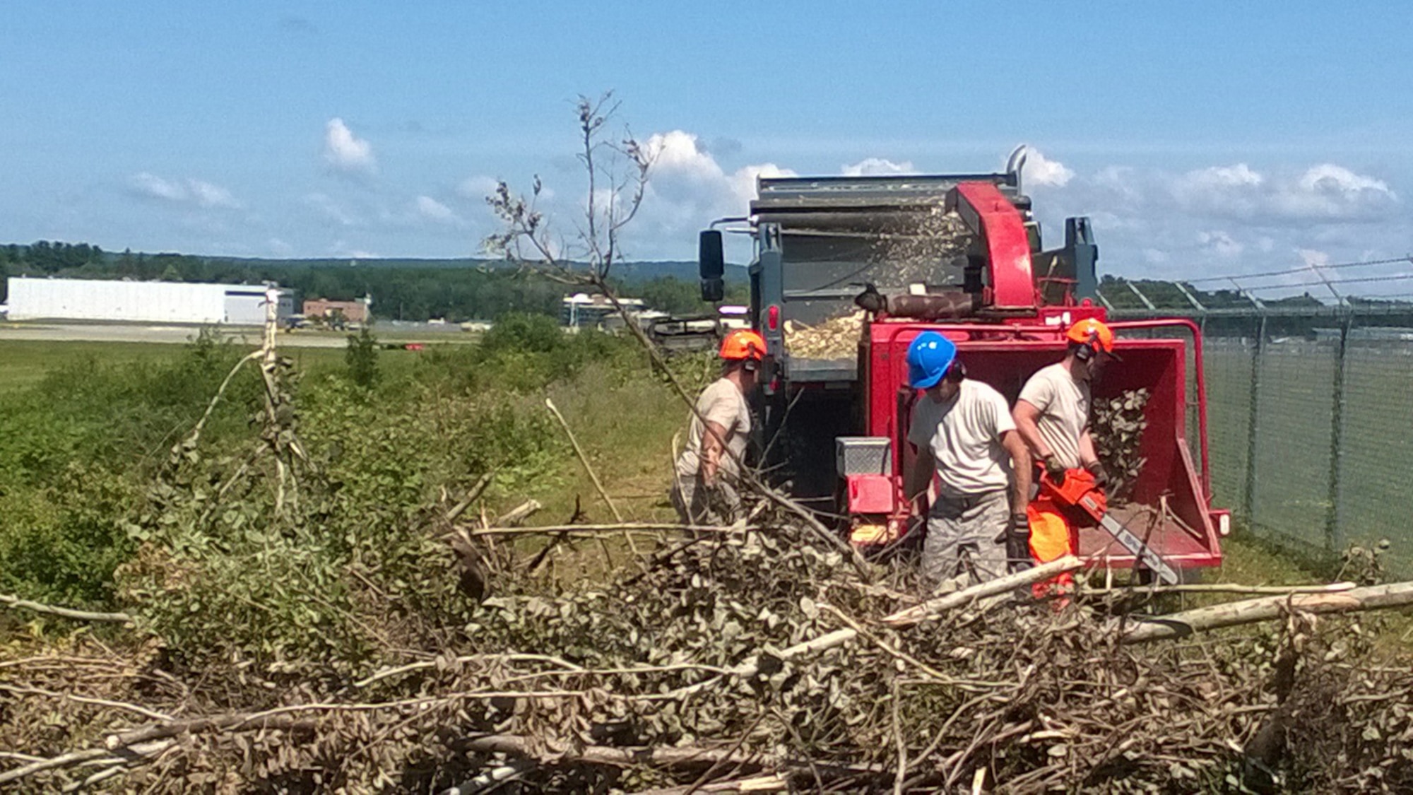 Members of the 109th Airlift Wing clear trees that were blocking Schenectady County Airport Authority's view of the ramp on July 23, 2015. The request came shortly after the 109th AW received new equipment as part of a debris clearance package to support domestic operations. The 109th Logistics Readiness Squadron's Vehicle Maintenance Flight took the tree clearing request as another training opportunity for members. (Courtesy photo/Released)