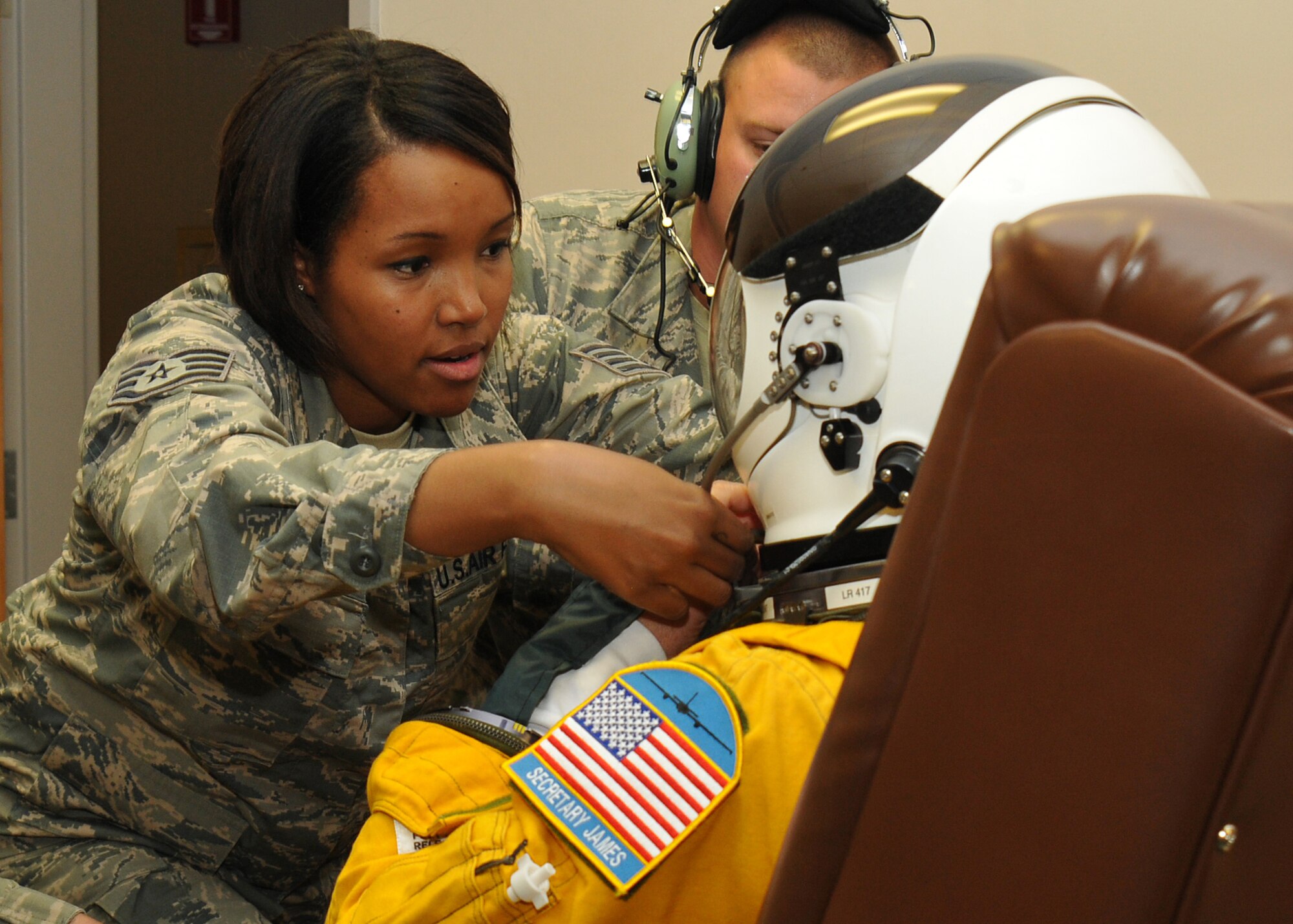 Staff Sgt. Virgie Yi, 9th Physiological Support Squadron assistant non-commissioned officer in charge of launch and recovery, adjusts the helmet for the high-altitude pressure suit of Secretary of the Air Force Deborah Lee James at Beale Air Force Base, California, Aug. 11, 2015. The specialized pressure suit allows U-2 Dragon Lady pilots to safely fly at altitudes reaching 70,000 feet. James visited Beale to receive a first-hand perspective of high-altitude intelligence, surveillance and reconnaissance from collection to dissemination. (U.S. Air Force photo by Senior Airman Dana J. Cable)