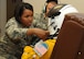 Staff Sgt. Virgie Yi, 9th Physiological Support Squadron assistant non-commissioned officer in charge of launch and recovery, adjusts the helmet for the high-altitude pressure suit of Secretary of the Air Force Deborah Lee James at Beale Air Force Base, California, Aug. 11, 2015. The specialized pressure suit allows U-2 Dragon Lady pilots to safely fly at altitudes reaching 70,000 feet. James visited Beale to receive a first-hand perspective of high-altitude intelligence, surveillance and reconnaissance from collection to dissemination. (U.S. Air Force photo by Senior Airman Dana J. Cable)