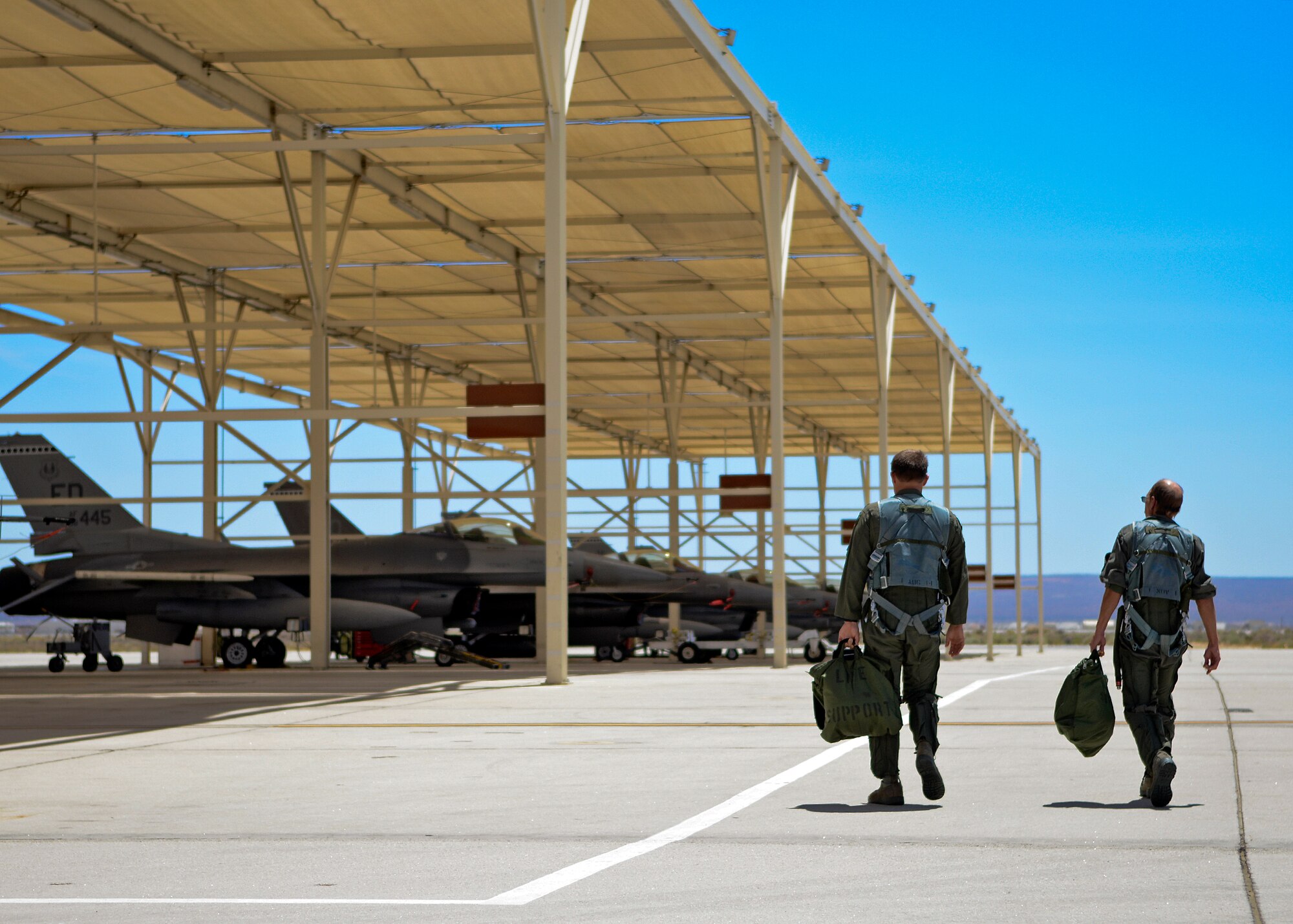 Capt. Joe Schenkel (left), 416th Flight Test Squadron F-16 test pilot, and Greg Welsh, 412th Aircraft Maintenance Squadron maintenance manager, walk out to an F-16 for Welsh’s familiarization flight that occurred Aug. 4, as part of the 412th Operations and Maintenance Immersion Program. Welsh is a 33-year veteran maintainer who was nominated by his supervisor for this program which was created to give operators and maintainers the opportunity to create positive interaction so both gain insight into each other’s work dynamic. (U.S. Air Force photo by Jet Fabara)