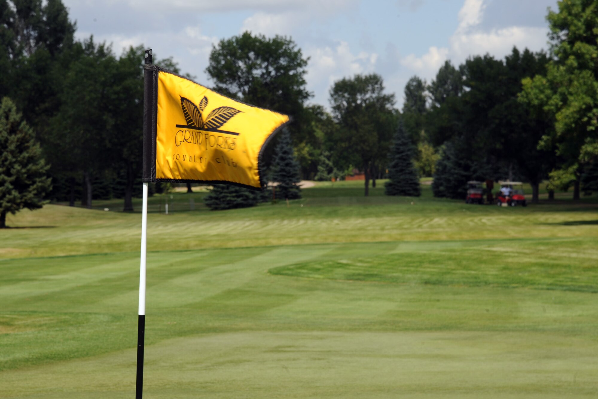 A flag waves in the wind at the Grand Forks Country Club Aug. 10, 2015, in Grand Forks, North Dakota. Nineteen four-man teams made up of golfers from Grand Forks Air Force Base and the local community members played in the tournament. (U.S. Air Force photo by Senior Airman Desiree Economides/Released)