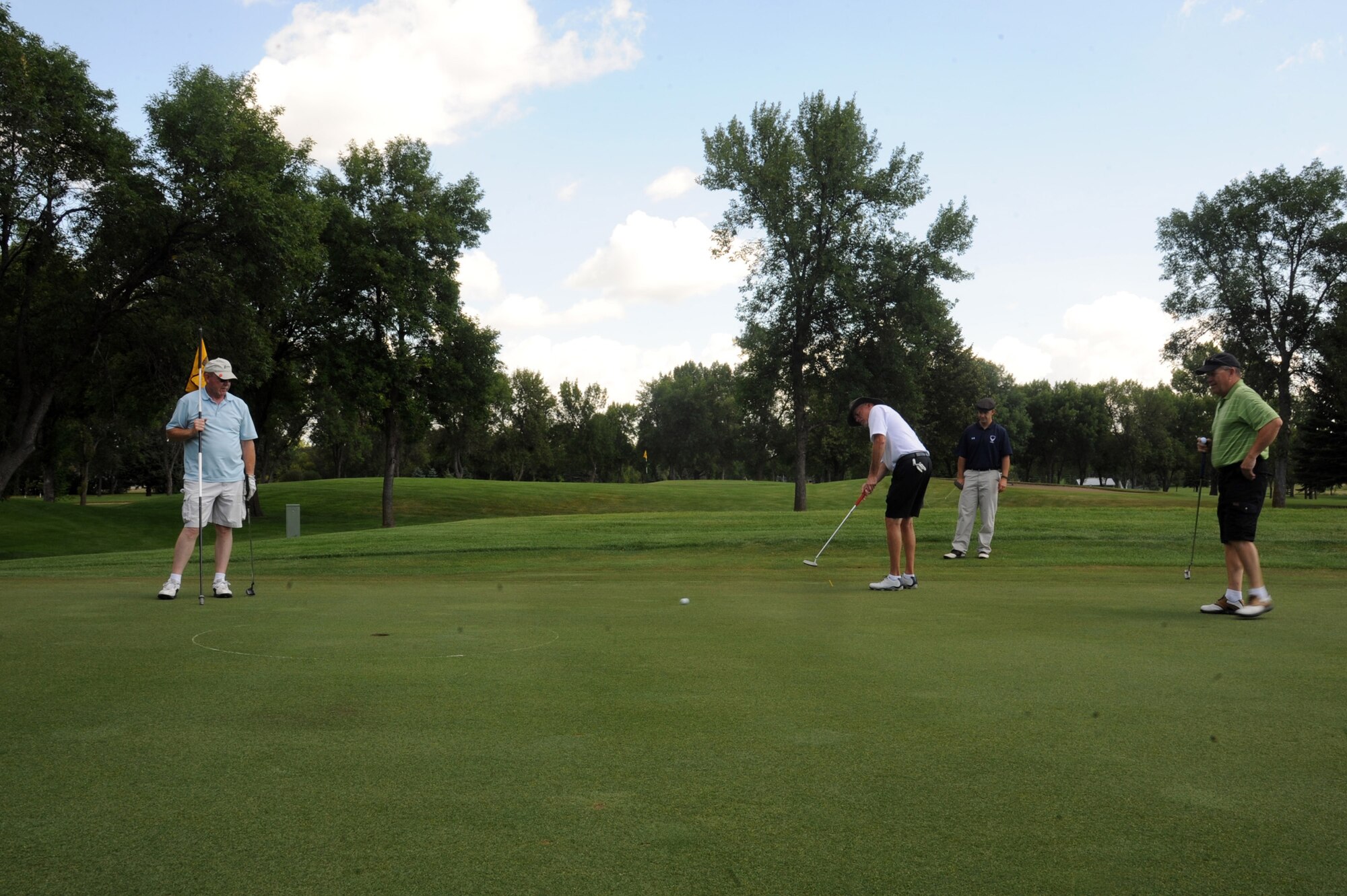 Participants play in the biannual Military Affairs Committee golf scramble Aug. 10, 2015, at the Grand Forks Country Club in Grand Forks, North Dakota. Golfers play in four-man teams twice a year for friendly competition and camaraderie. (U.S. Air Force photo by Senior Airman Desiree Economides/Released)