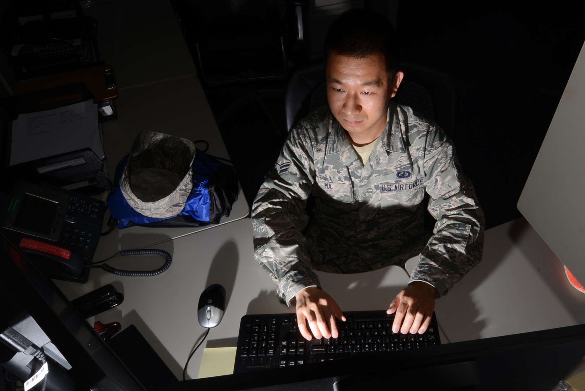 U.S. Air Force Airman 1st Class Bin Ma, 20th Comptroller Squadron financial services technician, works after hours reviewing finances for Airmen at Shaw Air Force Base, S.C., July 31, 2015. Ma is applying to commission in the Medical Service Corps for a position in hospital administration which is in charge of resources, personnel or money, to keep clinics running. (U.S. Air Force photo by Senior Airman Michael Cossaboom/Released)