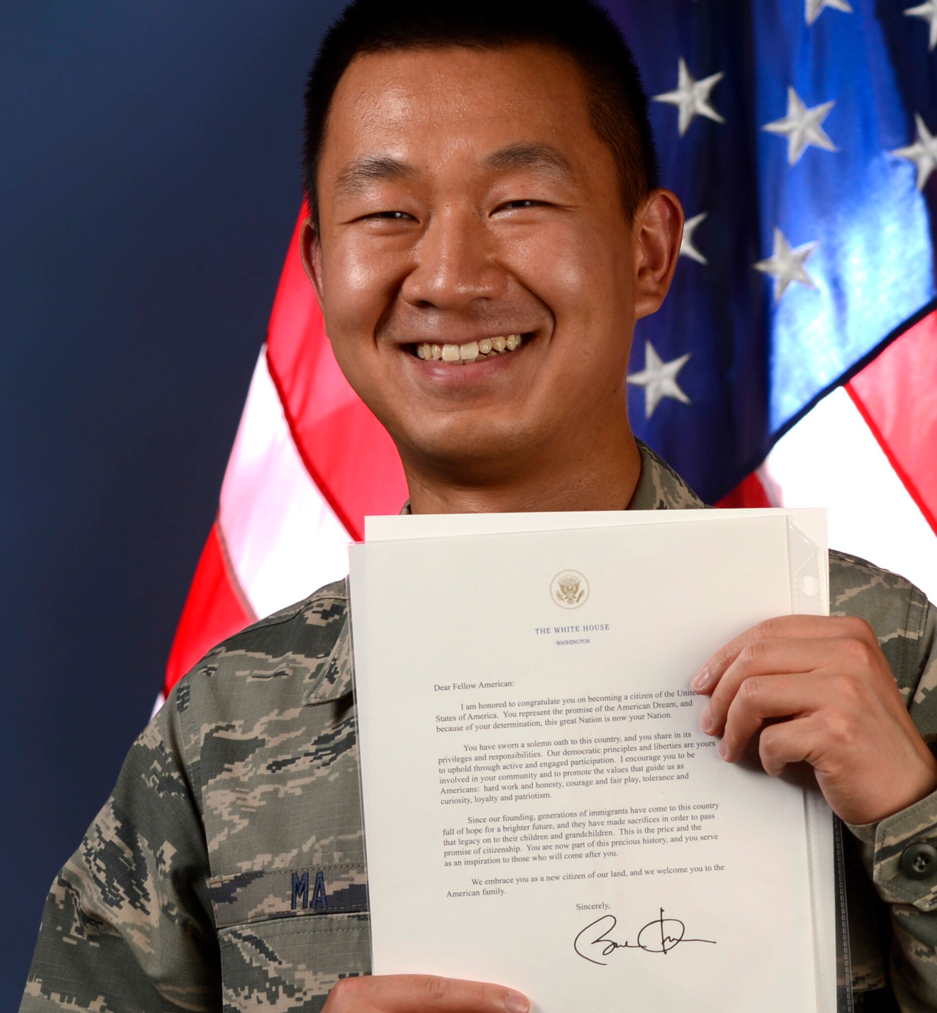 U.S. Air Force Airman 1st Class Bin Ma, 20th Comptroller Squadron financial services technician, holds his letter from president Barak Obama congratulating him on becoming a citizen of the United States, Shaw Air Force Base, S.C., July 31, 2015. Ma arrived in the United States seven years ago from Muhan, China, and received his U.S. citizenship in January 2015. (U.S. Air Force photo by Senior Airman Diana M. Cossaboom/Released)
