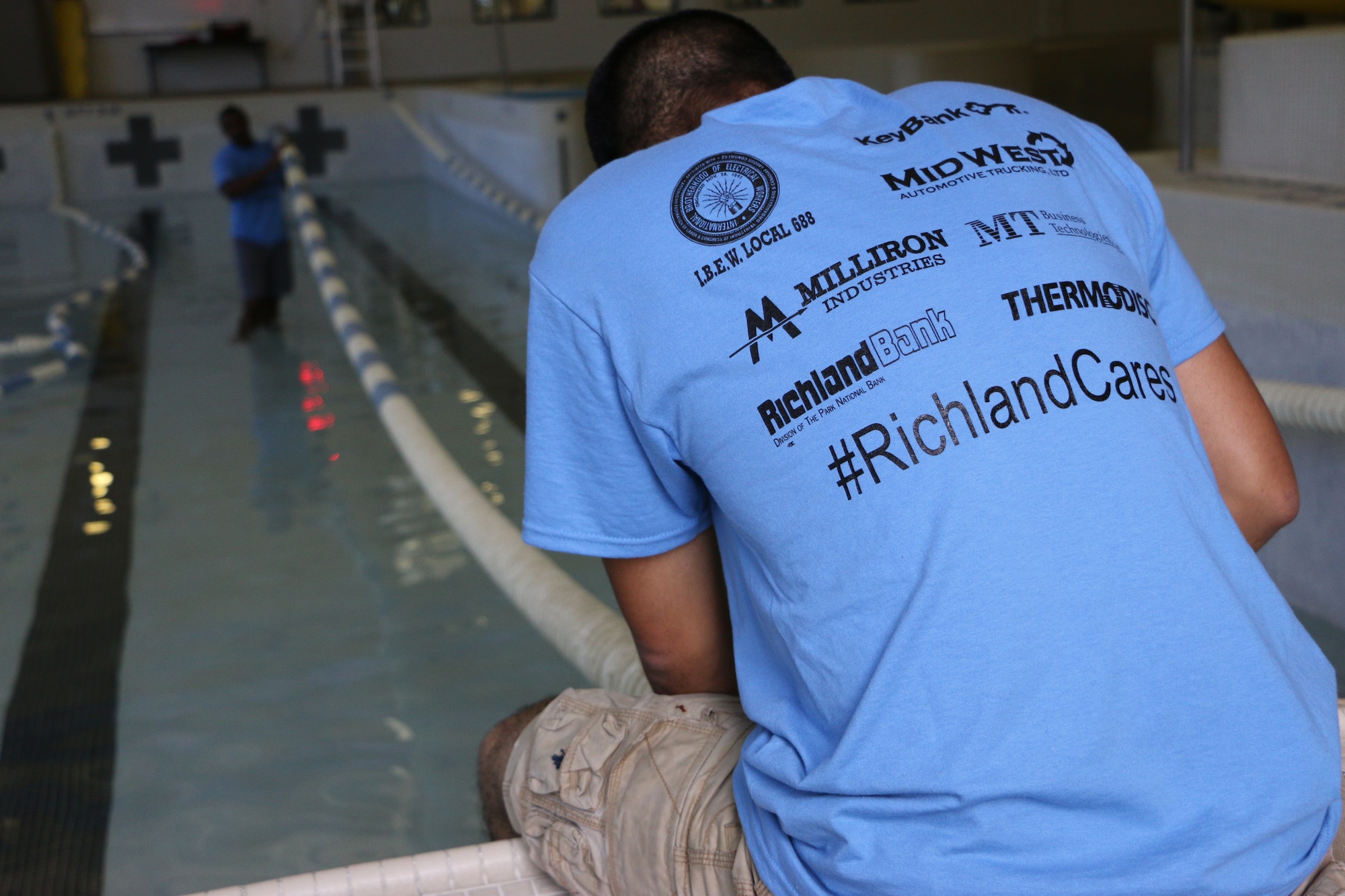 Ohio Air National Guardsmen from the 179th Airlift Wing and 200th RED HORSE, Mansfield, Ohio, participate in a United Way community volunteer project called "Day of Caring" Aug. 7, 2015. Guardsmen helped at the Mansfield YMCA to scrub clean the drained pool, paint walls and spread mulch in the children’s playground. (U.S. Air National Guard photo by Tech. Sgt. Joe Harwood\Released)