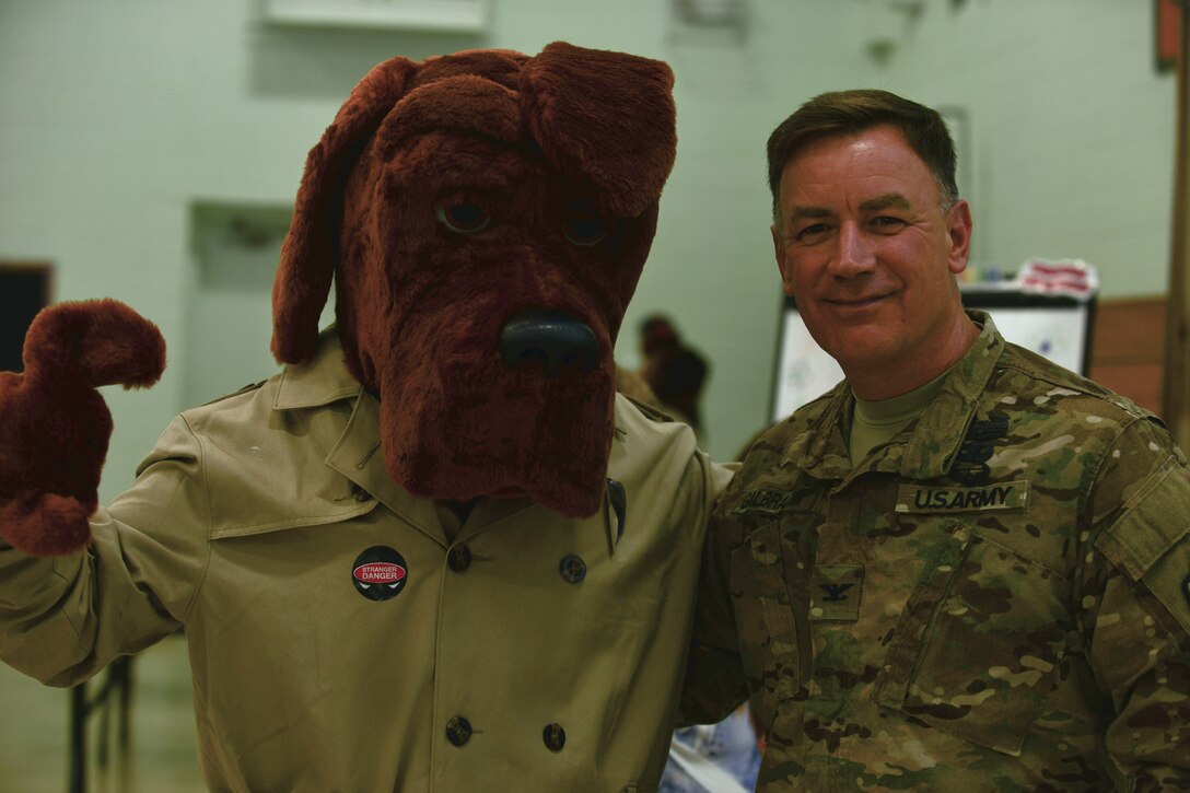 U.S. Army Col. William Galbraith, 733rd Mission Support Group commander, poses with McGruff the Crime Dog during the Fort Eustis back-to-school block party at the Middle School and Teen Center at Fort Eustis, Va., Aug. 11, 2015. The focus of this year’s party included school and community safety, awareness and education. (U.S. Air Force photo by Staff Sgt. Natasha Stannard/Released)