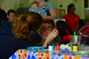 Sean Adcox gets his face painted during the Fort Eustis back-to-school block party at the Middle School and Teen Center at Fort Eustis, Va., Aug. 11, 2015. The block party involved activities for children as well as informational booths from various base agencies. (U.S. Air Force photo by Staff Sgt. Natasha Stannard/Released)