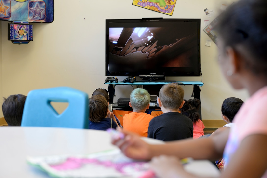 A group of children watch a movie at the youth center at Langley Air Force Base, Va., July 24, 2015. The center recently won the Boys and Girls Club of America’s Youth Program of the Year for the Virginia and Washington D.C. area for the third year in a row. (U.S. Air Force photo by Airman 1st Class Derek Seifert/Released)