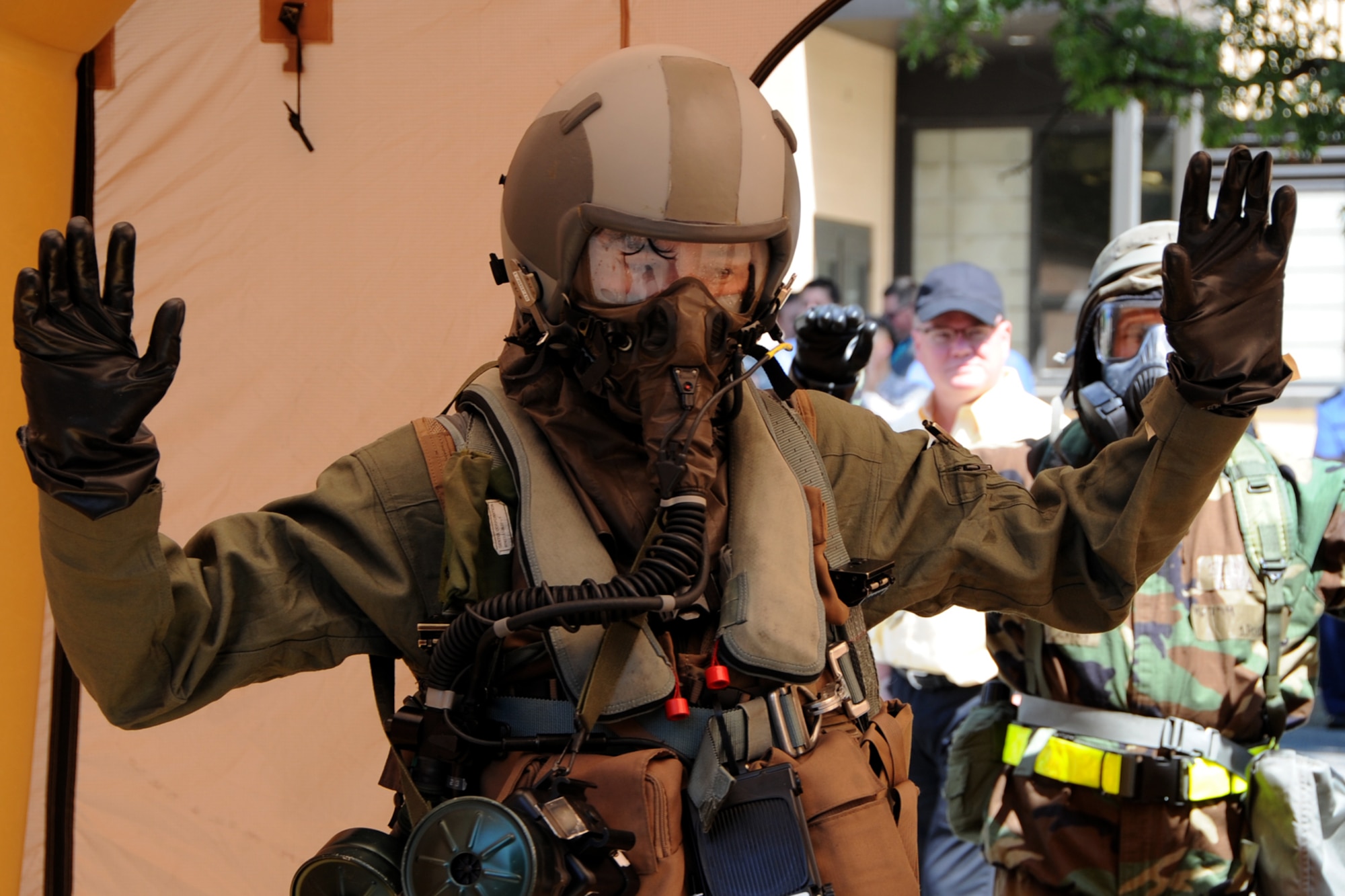 An F-16 fighter pilot from the 113th Air National Guard demonstrates aircrew contamination control area procedures during the Air Force Chemical, Biological, Radiological and Nuclear Defense Demonstration Day on Joint Base Andrews, Md., Aug. 5, 2015. The event gave an overview of Air Force CBRN defense capabilities to Office of the Secretary of Defense and joint leaders who directly influence DoD investment decisions in new CBRN defense technologies. (U.S. Air Force photo/Staff Sgt. Matt Davis)