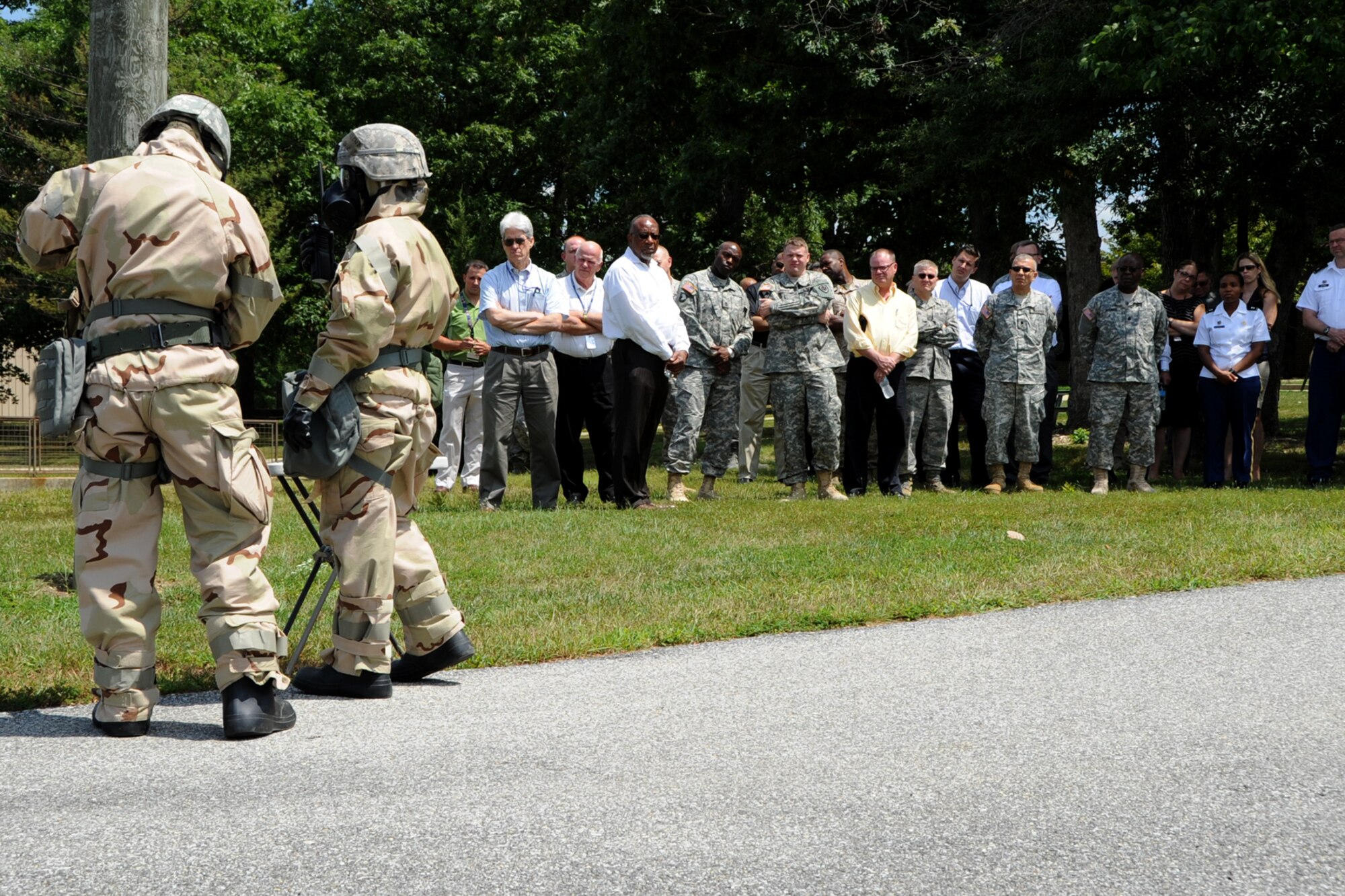 Attendees watch Airmen conduct CBRN reconnaissance during the Air Force Chemical, Biological, Radiological and Nuclear Defense Demonstration Day on Joint Base Andrews, Md., Aug. 5, 2015. The event gave an overview of Air Force CBRN defense capabilities to Office of the Secretary of Defense and joint leaders who directly influence DoD investment decisions in new CBRN defense technologies. (U.S. Air Force photo/Staff Sgt. Matt Davis)