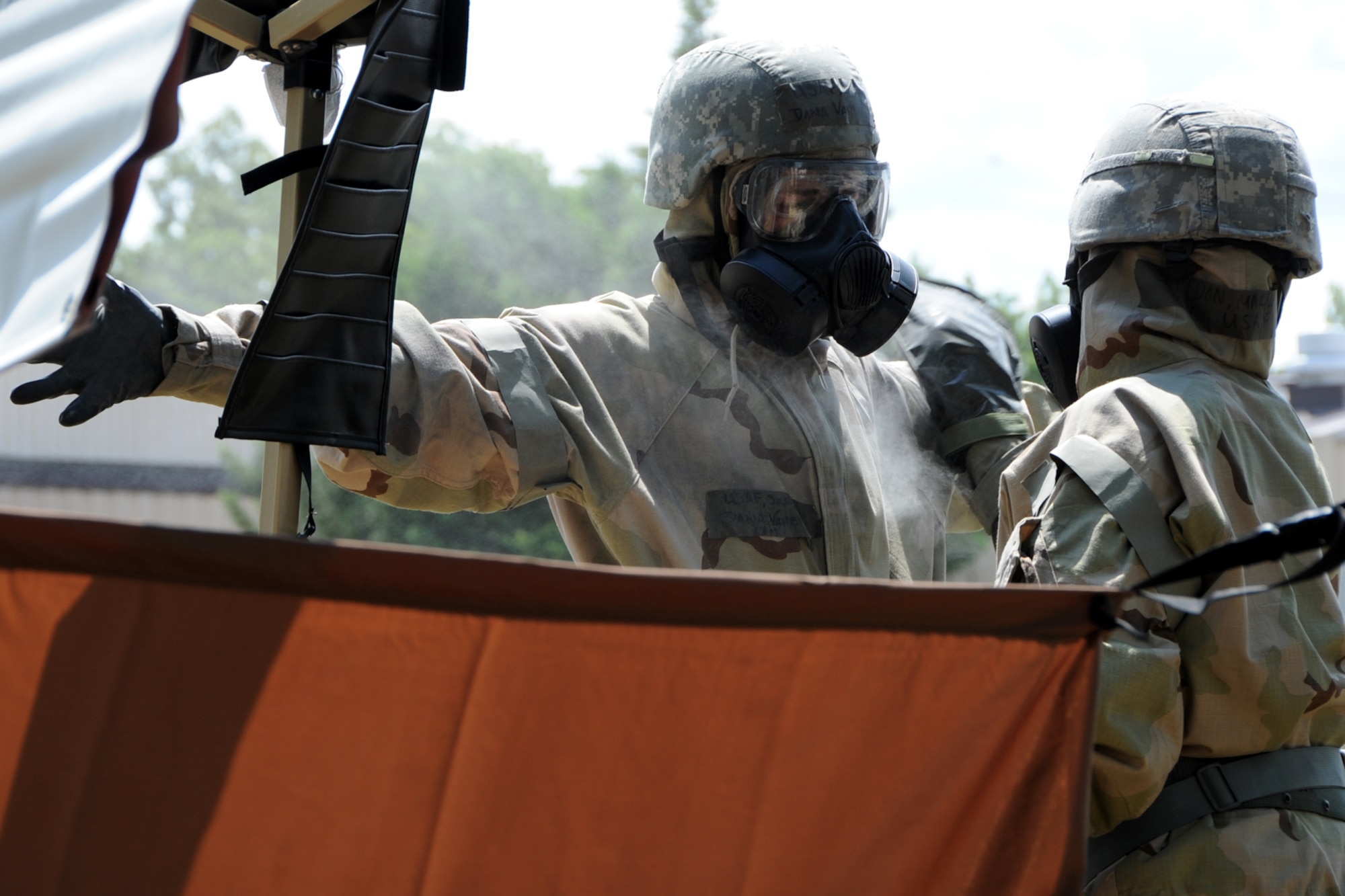 Airmen process through a contamination control area during the Air Force Chemical, Biological, Radiological and Nuclear Defense Demonstration Day on Joint Base Andrews, Md., Aug. 5, 2015. The event gave an overview of Air Force CBRN defense capabilities to Office of the Secretary of Defense and joint leaders who directly influence DoD investment decisions in new CBRN defense technologies. (U.S. Air Force photo/Staff Sgt. Matt Davis)