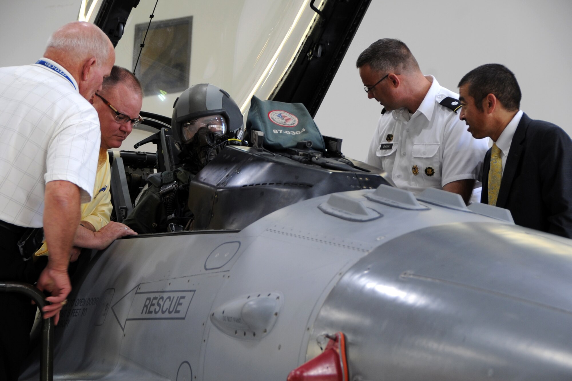 Attendees watch an F-16 fighter pilot from the 113th Air National Guard demonstrate aircrew entry during the Air Force Chemical, Biological, Radiological and Nuclear Defense Demonstration Day on Joint Base Andrews, Md., Aug. 5, 2015. The event gave an overview of Air Force CBRN defense capabilities to Office of the Secretary of Defense and joint leaders who directly influence DoD investment decisions in new CBRN defense technologies. (U.S. Air Force photo/Staff Sgt. Matt Davis)