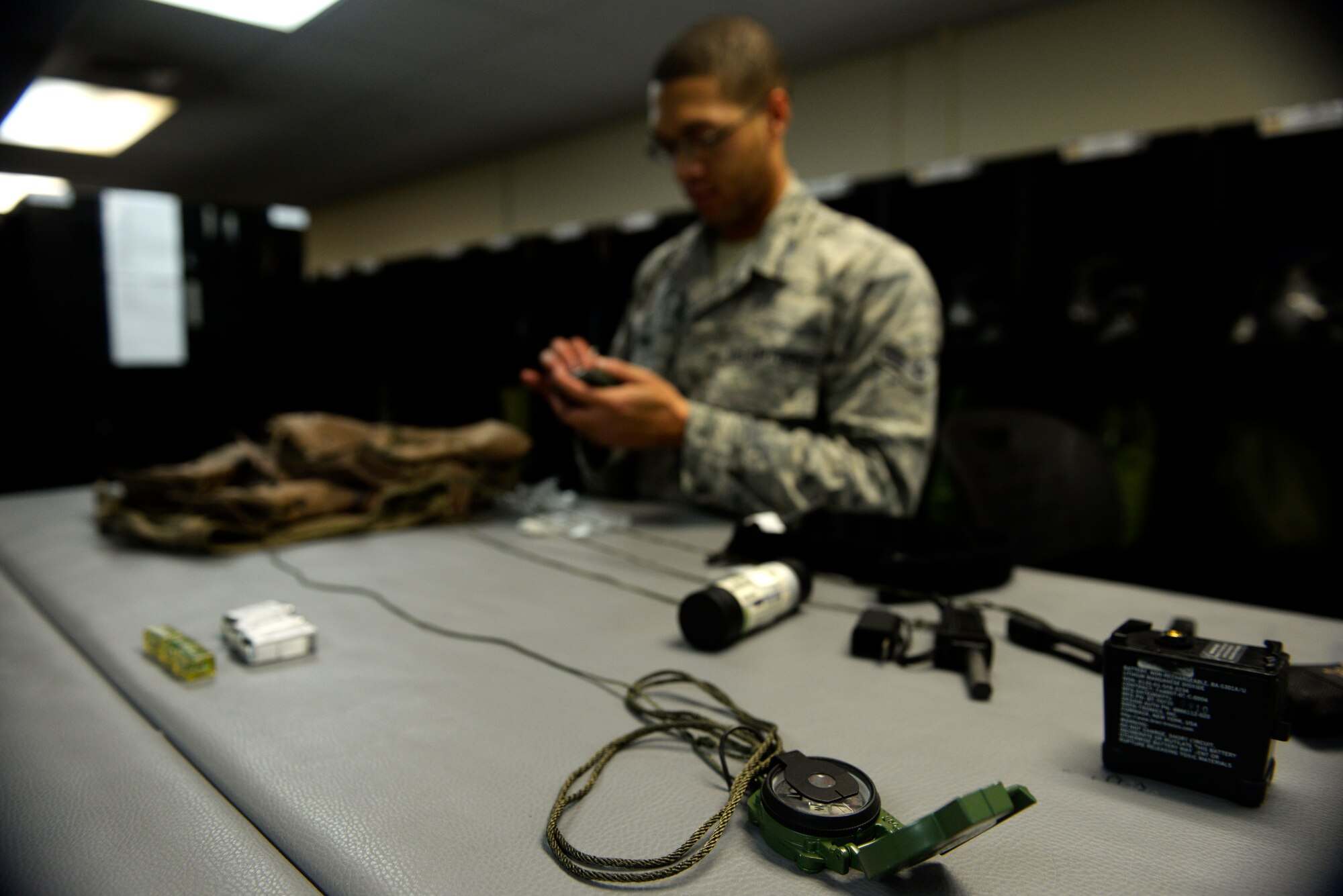 Airman 1st Class Michael Banks, 20th Expeditionary Bomb Squadron aircrew flight equipment specialist, checks a survival vest worn by B-52 Stratofortress pilots Aug. 12, 2015, at Andersen Air Force Base, Guam. Survival vests include infrared beacons, water, compass, medical supplies and other essential tools to help aircrews survive after an emergency landing or ejection. (U.S. Air Force photo by Staff Sgt. Alexander W. Riedel/Released)