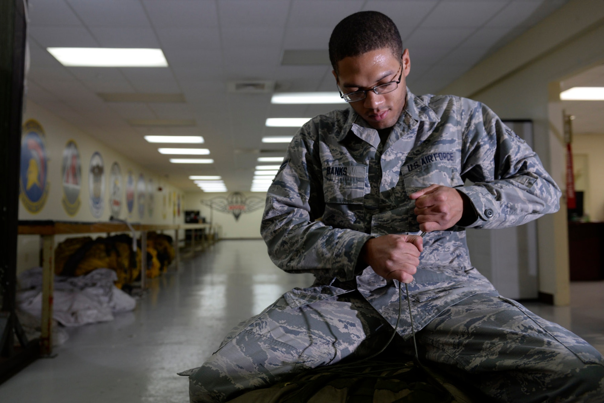 Airman 1st Class Michael Banks, 20th Expeditionary Bomb Squadron aircrew flight equipment specialist, packages a B-52 Stratofortress drag chute Aug. 12, 2015, at Andersen Air Force Base, Guam. Drag chutes safely slow aircraft upon landing and are essential safety equipment. (U.S. Air Force photo by Staff Sgt. Alexander W. Riedel/Released)