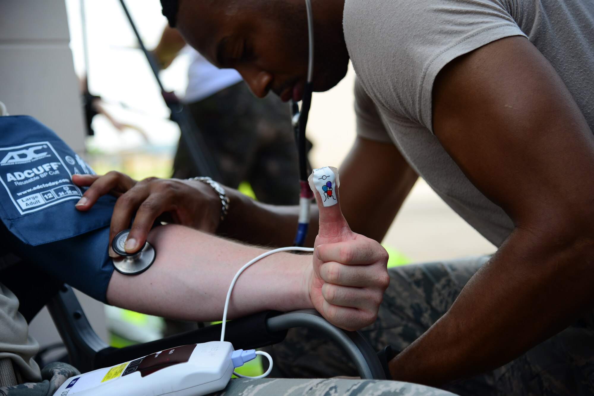 Senior Airman Akil Ochoa, a 51st Medical Operations Squadron medical technician, checks the blood pressure, heart rate, and internal temperature of an Airman pre-and post-wear of chemical, biological, radiological and nuclear protection suits during an integrated base emergency response capability training exercise held at Osan Air Base, Republic of Korea, Aug 4, 2015. Studies on the effect CBRN equipment has on the wearer show that temperature increases while wearing the suits. The increased heat can cause a dangerous spike in the core body temperature of the wearer, resulting in loss of dexterity, cognitive thought and reduced motor skills.
(U.S. Air Force photo/Staff Sgt. Amber Grimm)