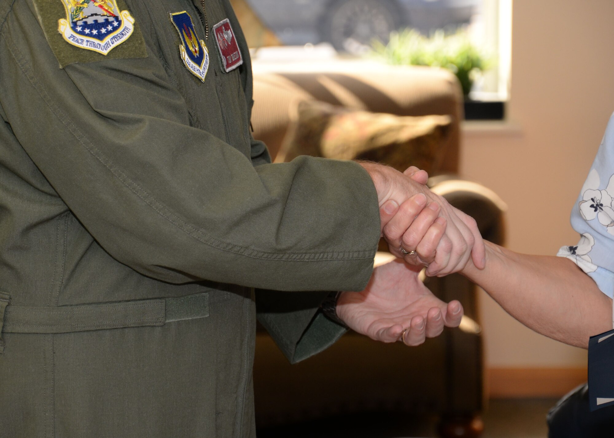 U.S. Air Force Col. Thomas D. Torkelson, left, 100th Air Refueling Wing commander, coins Maureen Morley, 100th Force Support Squadron Child Development Center room leader from Beck Row, Suffolk, to commemorate her 30 years of service to the U.S. Air Force July 29, 2015, at the CDC on RAF Mildenhall, England. Morley came to work at RAF Mildenhall before the Child Care Act so has seen the child care offered to military families grow and develop. (U.S. Air Force photo by Gina Randall/Released)