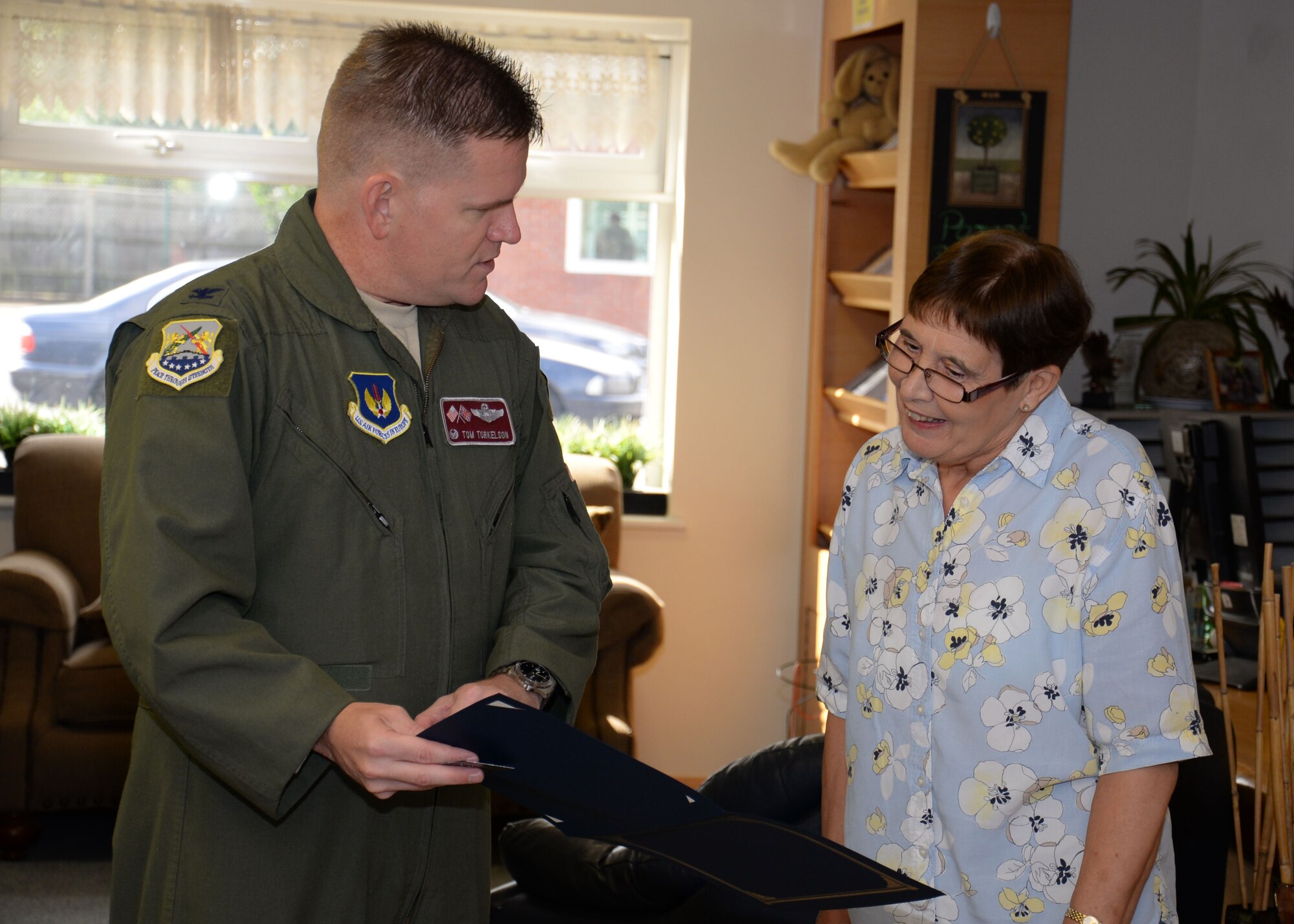U.S. Air Force Col. Thomas D. Torkelson, left, 100th Air Refueling Wing commander, presents Maureen Morley, 100th Force Support Squadron Child Development Center room leader from Beck Row, Suffolk, with a certificate to commemorate her 30 years of service to the U.S. Air Force July 29, 2015, at the CDC on RAF Mildenhall, England. Morley retired July 31, 2015, after dedicating her career to the children and parents stationed at RAF Mildenhall. (U.S. Air Force photo by Gina Randall/Released)