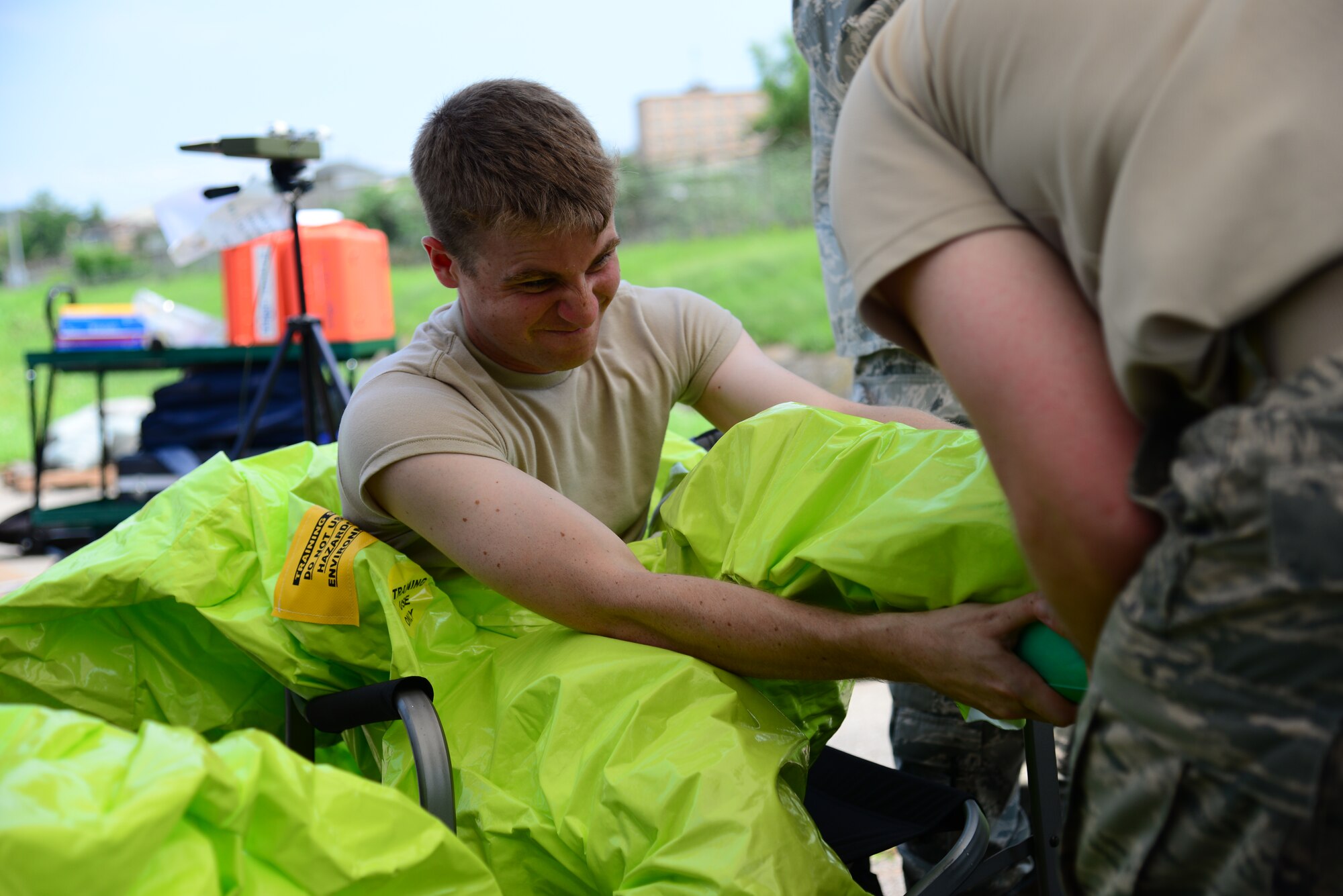 Airman 1st Class Benjamin Thompson, 51st Civil Engineer Squadron emergency management apprentice, is assisted in donning his level A chemical, biological, radiological and nuclear protection suit during an integrated base emergency response capability training exercise at Osan Air Base, Republic of Korea, Aug 4, 2015. The level A CBRN suit is a fully encapsulated ensemble, with a self-contained breathing apparatus, used to respond to “all-hazards” situations.
(U.S. Air Force photo/Staff Sgt. Amber Grimm)