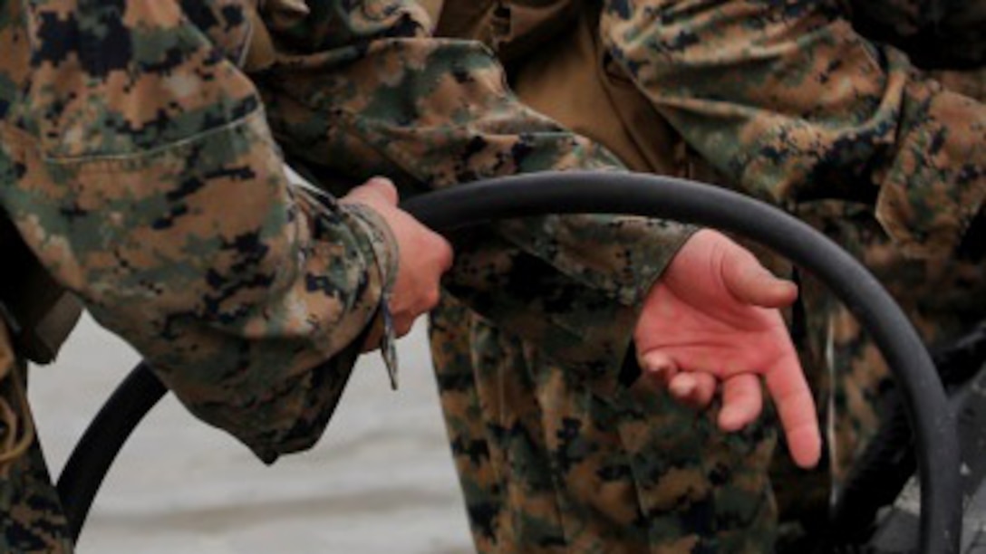 A Marine with 2nd Radio Battalion prepares a Zodiac Combat Rubber Raiding Craft shortly before conducting amphibious operations at Marine Corps Base Camp Lejeune, North Carolina Aug. 10, 2015. The amphibious operations were part of a two-week radio reconnaissance operator’s course. The unit holds the course in order to ready its radio operators for real world operations.