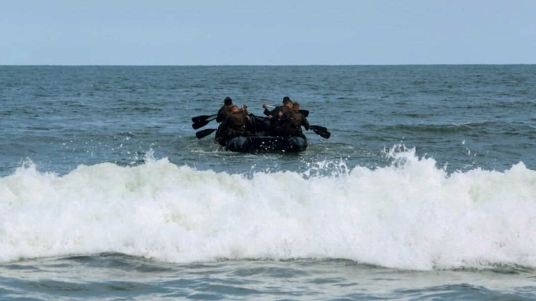 Marines with 2nd Radio Battalion paddle past the surf in a Zodiac Combat Rubber Raiding Craft as part of a radio reconnaissance operator’s course at Marine Corps Base Camp Lejeune, North Carolina, Aug. 10, 2015. The Marines were taking part in the course giving them a chance to break the mold of their average day. The unit holds the course in order to ready its radio operators for real world operations.