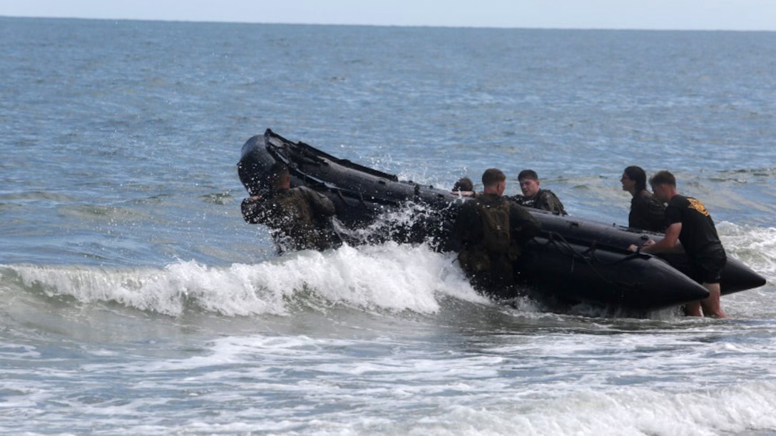 Marines with 2nd Radio Battalion fight the surf as they take a Zodiac Combat Rubber Raiding Craft out into the water as part of a radio reconnaissance operator’s course at Marine Corps Base Camp Lejeune, North Carolina, Aug. 10, 2015. The Marines were taking part in the course giving them a chance to break the mold of their average day. The unit holds the course in order to ready its radio operators for real world operations.