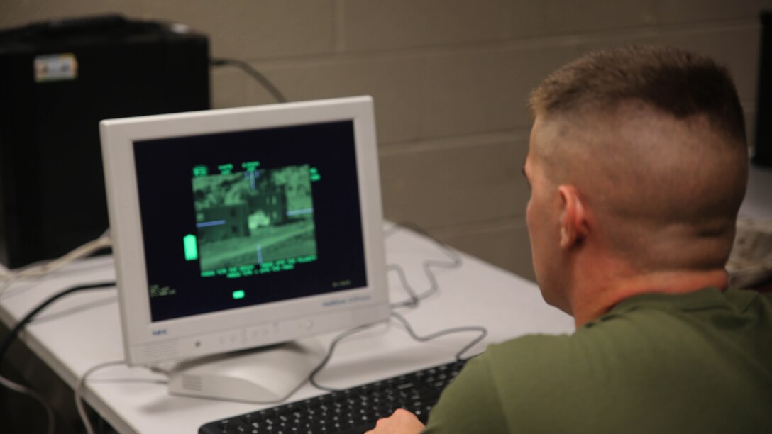 Lance Cpl. Rhet McNeal, an anti-tank missile man with Combined Anti-Armor Team Platoon, Weapons Company, 2nd Battalion, 2nd Marine Regiment, supervises a simulated engagement on a computer screen during a simulated anti-armor exercise at Camp Lejeune, N.C., Aug. 8, 2015. The screen allowed Marines to supervise simulated engagements and offer assistance if necessary. 