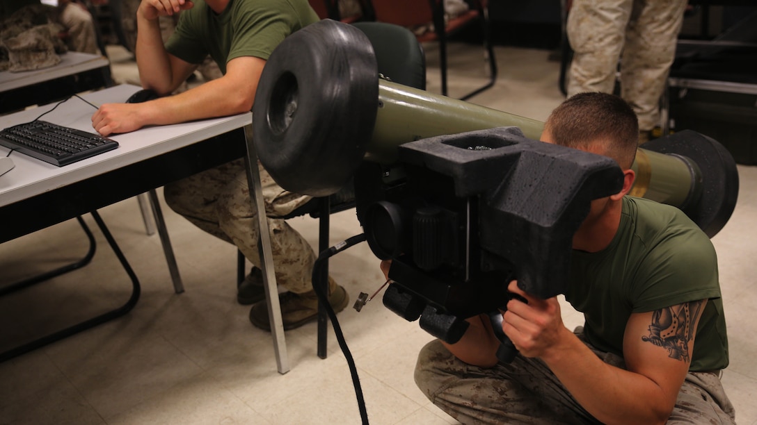 Lance Cpl. Shaun Thompson, an anti-tank missile man with Combined Anti-Armor Team Platoon, Weapons Company, 2nd Battalion, 2nd Marine Regiment, operates a simulated FGM-148 Javelin during a simulated anti-armor exercise at Camp Lejeune, N.C., Aug. 8, 2015. Marines could watch the simulated engagement on its corresponding computer screen, supervising the gunner’s performance. 