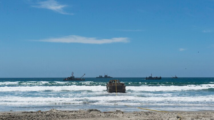 Marines with Bulk Fuel Co., 1st Marine Logistics Group, team up with Sailors from Amphibious Construction Battalion 1 to perform a beach unloading exercise using the Beach Termination Unit, in Coronado, California, Aug. 1-4, 2015. Approximately 30 Marines with Bulk Fuel Company, 7th Engineer Support Battalion, 1st Marine Logistics Group, teamed up with Sailors from Amphibious Construction Battalion 1 to conduct a beach unloading exercise. What made the training unique was the use of the BTU, which allows Marines to transfer fuel from a ship out in the ocean to Marines on land.