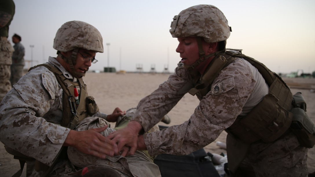 U.S. Marines Staff Sgt. William Nessola, the communications maintenance chief with the Ground Combat Element, Special Purpose Marine Air-Ground Task Force-Crisis Response-Central Command from Savannah, Georgia, and Cpl. Jordan Trujillo, an air delivery specialist with the Logistics Combat Element from Fullerton, California, work together to assess and treat their patient during the final test of the Combat Life Saver course in Southwest Asia, Aug. 12, 2015. During the final test the students work in pairs and each pair is given a different scenario where they must assess, treat and pass along a patient to a follow-on medical provider. The SPMAGTF corpsmen provide a three-day CLS course teaching combat triage and emergency trauma care to improve the survivability of the Crisis Response Company and coalition partners.