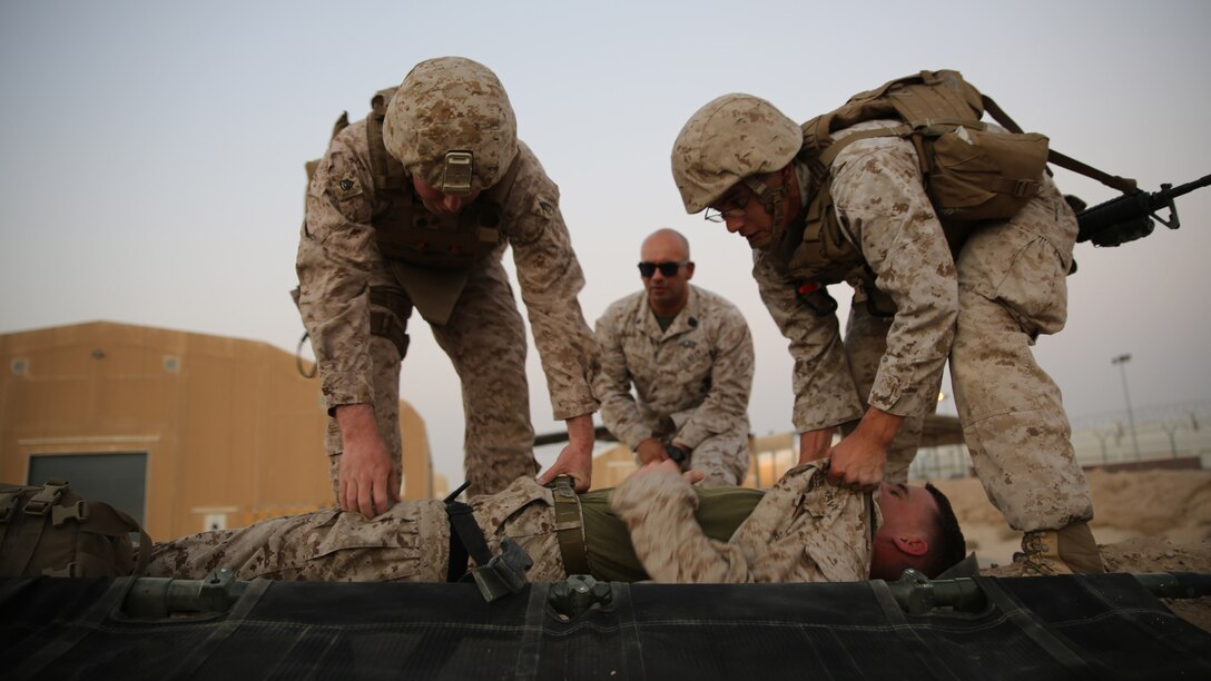 U.S. Marines Staff Sgt. William Nessola, the communications maintenance chief with the Ground Combat Element, Special Purpose Marne Air-Ground Task Force-Crisis Response-Central Command from Savannah, Georgia, and Cpl. Jordan Trujillo, an air delivery specialist with the Logistics Combat Element, from Fullerton, California, work together to put their patient on a stretcher during the final test of the Combat Life Saver course in Southwest Asia, Aug. 12, 2015. During the final test the students work in pairs and each pair is given a different scenario where they must assess, treat and pass along a patient to a follow-on medical provider. The SPMAGTF corpsmen provide a three-day CLS course teaching combat triage and emergency trauma care to improve the survivability of the Crisis Response Company and coalition partners.