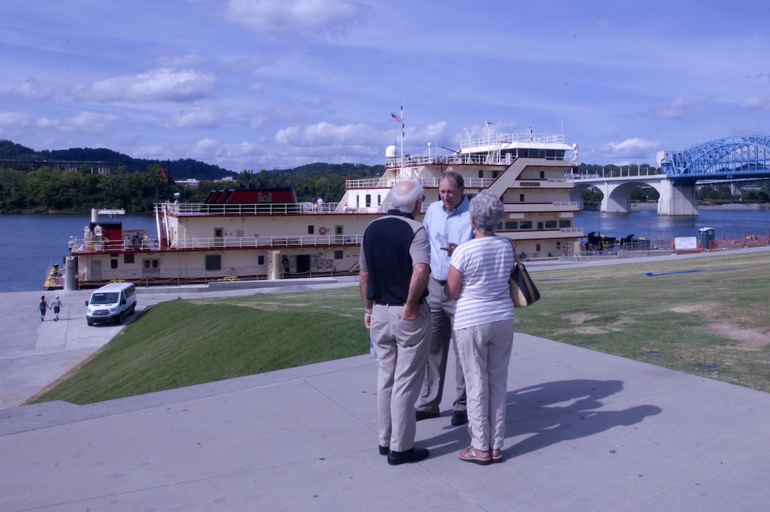 Jimmy Waddle (Center), U.S. Army Corps of Engineers Nashville District Engineering and Construction Division chief, encourages a couple to board the Motor Vessel Mississippi to enjoy a public tour of the vessel docked at Ross's Landing in Chattanooga, Tenn., Aug. 7, 2015. The M/V Mississippi spends more than 90 percent of its time as a working towboat, moving barges, equipment and supplies on the lower Mississippi River.  The M/V Mississippi, built in 1993 by Halter Marine, is the fifth Army Corps of Engineers towboat to bear the name.  It is the largest diesel towboat in the United States at 241-feet long, 58-feet wide and five stories high.  Three 2,100-horsepower diesel engines power the vessel.
