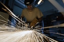 Master Sgt. Jim Vlacich, a machinist with the 106th Rescue Wing metal technologies shop, grinds down a section of metal at Francis S. Gabreski Air National Guard Base, N.Y., Aug. 6, 2015. Aircraft metals technology specialists are responsible for machining parts, welding, creating items from scratch and welding parts necessary for keeping the 106th RQW’s aircraft flying. (U.S. Air National Guard photo/Staff Sgt. Christopher S. Muncy)