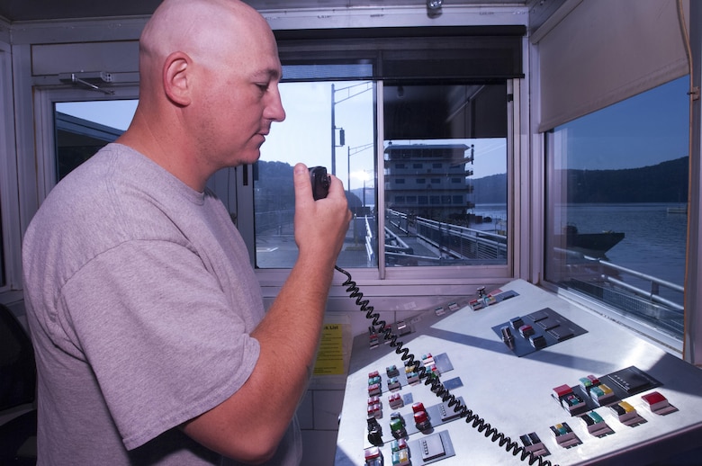 Lock Operator Brandon Smith communicates with the Motor Vessel Mississippi captain as the towboat prepares to lock through Guntersville Lock in Grant, Ala., the morning of Aug. 9, 2015.  The lock, which is located at Tennessee River Mile 349, is maintained and operated by the U.S. Army Corps of Engineers Nashville District.  The vessel is transporting the Mississippi River Commission, which is conducting a low water inspection of the Tennessee River.