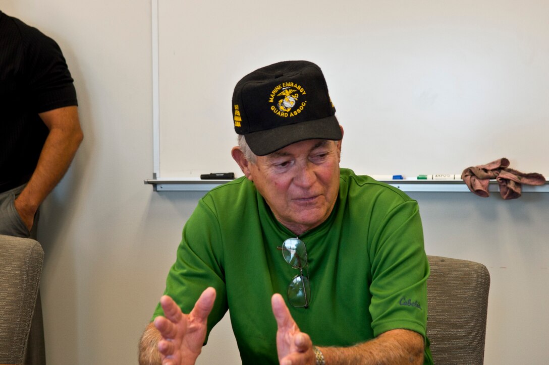 Cpl. Larry Morris talks with Marines during his visit to the Marine Corps Embassy Security Group aboard Marine Corps Base Quantico. Morris and the two other Marines who closed the embassy in Havana in 1961, visited MCESG in preparation for their return to Cuba to help reopen the embassy after 54 years. 