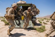 U.S. Marines with Company B, 1st Battalion, 3rd Marine Regiment, exit an assault amphibian vehicle as part of a Battalion Assault Course during an Integrated Training Exercise (ITX) at Marine Corps Air Ground Combat Center Twentynine Palms, Calif., Aug. 11, 2015. ITX is conducted to enhance the integration and warfighting capability from all elements of the Marine Air Ground Task Force. (U.S. Marine Corps photo by Lance Cpl. Clarence A. Leake/Released)