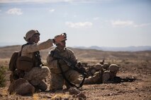 U.S. Marine Corps Sgt. Adam Ferretti, squad leader, and Cpl. Jacob Gomez, team leader with Company B, 1st Battalion, 3rd Marine Regiment, discuss the plan of attack as part of a Battalion Assault Course during an Integrated Training Exercise (ITX) at Marine Corps Air Ground Combat Center Twentynine Palms, Calif., Aug. 11, 2015. ITX is conducted to enhance the integration and warfighting capability from all elements of the Marine Air Ground Task Force. (U.S. Marine Corps photo by Lance Cpl. Clarence A. Leake/Released)