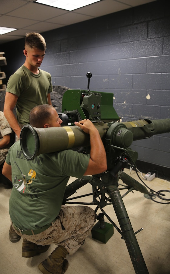 Lance Cpl. Hamdem Abushebab, front, an anti-tank missile man with Combined Anti-Armor Team Platoon, Weapons Company, 2nd Battalion, 2nd Marine Regiment, prepares to reload a simulated M41A4 Saber missile system during a simulated anti-armor exercise at Camp Lejeune, N.C., August 8, 2015. The simulated Saber featured removable tube-launched, optically-tracked, wire-guided missiles, allowing Marines to practice loading and unloading the system.. (U.S. Marine Corps photo by Cpl. Paul S. Martinez/Released)