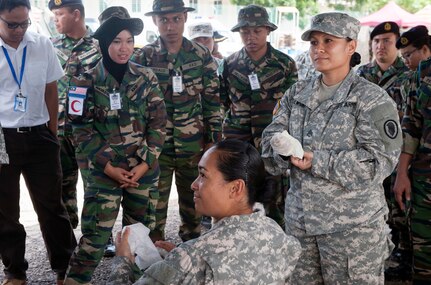 PORT DICKSON, Malaysia (Aug. 12, 2015) - U.S. Army Staff Sgt. Denise Wisniewski, Hawaii Army National Guard, Medical Detachment combat medic, teaches first responder medical techniques to members of the Malaysian armed forces as part of Exercise Keris Aman 2015 at the Segenting Camp.  Keris Aman is the largest multinational training event this year and is co-hosted by the Malaysian armed forces and U.S. Pacific Command with representatives from 29 nations participating. The goals and objectives of the training event are to increase participants' interoperability and peacekeeping skills prior to deployment to UN missions. 