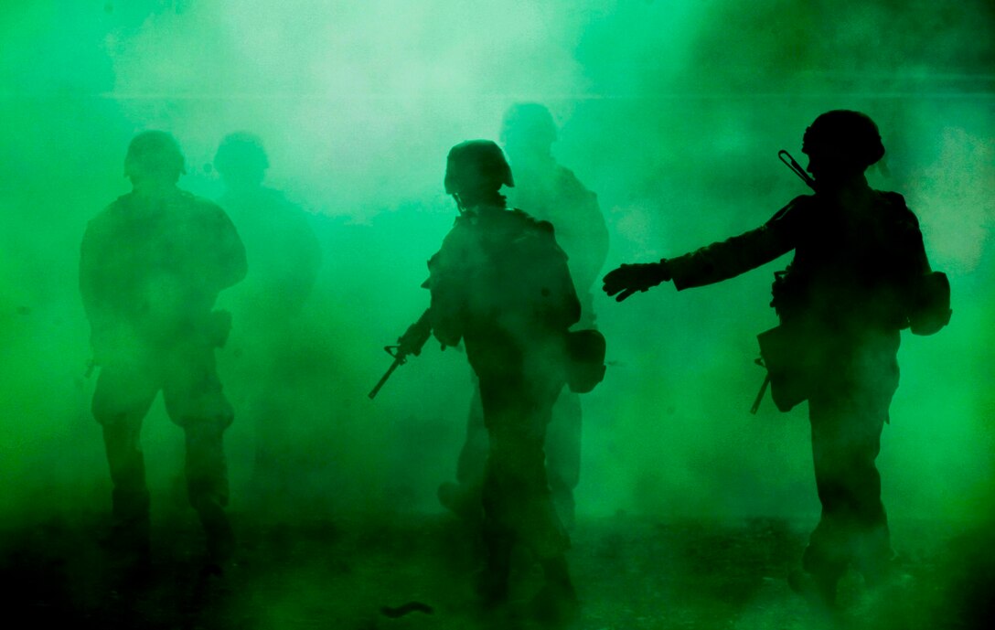 Marines with Company A, 1st Battalion, 7th Marine Regiment, use green smoke to provide concealment as they move through the simulated town during a Military Operation on Urban Terrain exercise aboard Marine Corps Air Ground Combat Center Twentynine Palms, California, Aug. 11, 2015. The MOUT exercise was part of an Integrated Training Exercise that allowed the Marines with Animal Company to showcase their different capabilities in preparation for future deployments.