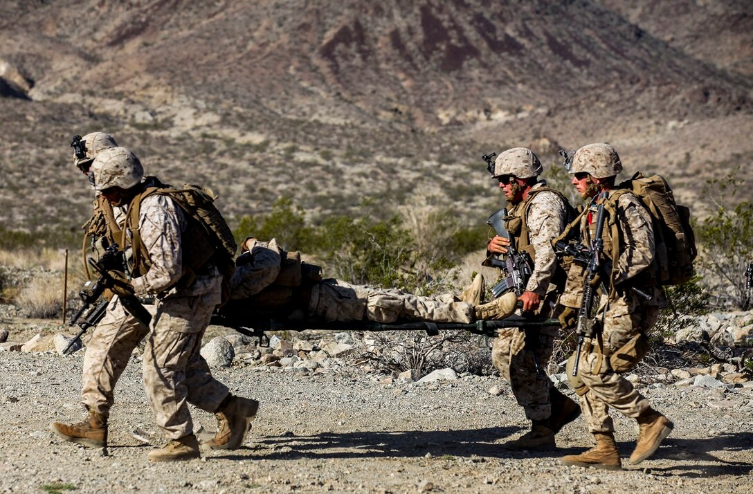 Marines and Corpsman with Company A, 1st Battalion, 7th Marine Regiment, evacuate a simulated casualty during a Military Operation on Urban Terrain exercise aboard Marine Corps Air Ground Combat Center Twentynine Palms, California, Aug. 11, 2015. The MOUT exercise was part of an Integrated Training Exercise held to evaluate unit performances in preparation for future deployments.