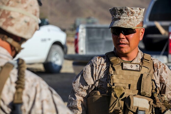 Brigadier Gen. Daniel Yoo, the deputy commanding general of 1st Marine Division, engages with Marines at a military operation on urban terrain exercise held by Company A, 1st Battalion, 7th Marine Regiment, as part of Integrated Training Exercise aboard Marine Corps Air Ground Combat Center Twentynine Palms, California, Aug. 11, 2015. Animal Company showcased the Marine Corps’ ability to execute tactically and proficiently in any area of operation.