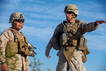 Colonel William Mccollough, the commanding officer of 1st Marine Regiment, 1st Marine Division, explains military operations on urban terrain procedures to Brig. Gen. Daniel Yoo, the deputy commanding general of 1st Marine Division, at a live-fire MOUT exercise conducted by Company A, 1st Battalion, 7th Marine Regiment, aboard Marine Corps Air Ground Combat Center Twentynine Palms, California, Aug. 11, 2015. The MOUT exercise was conducted as part of Integrated Training Exercise and allowed the Marines to practice many different capabilities in preparation for future deployments.