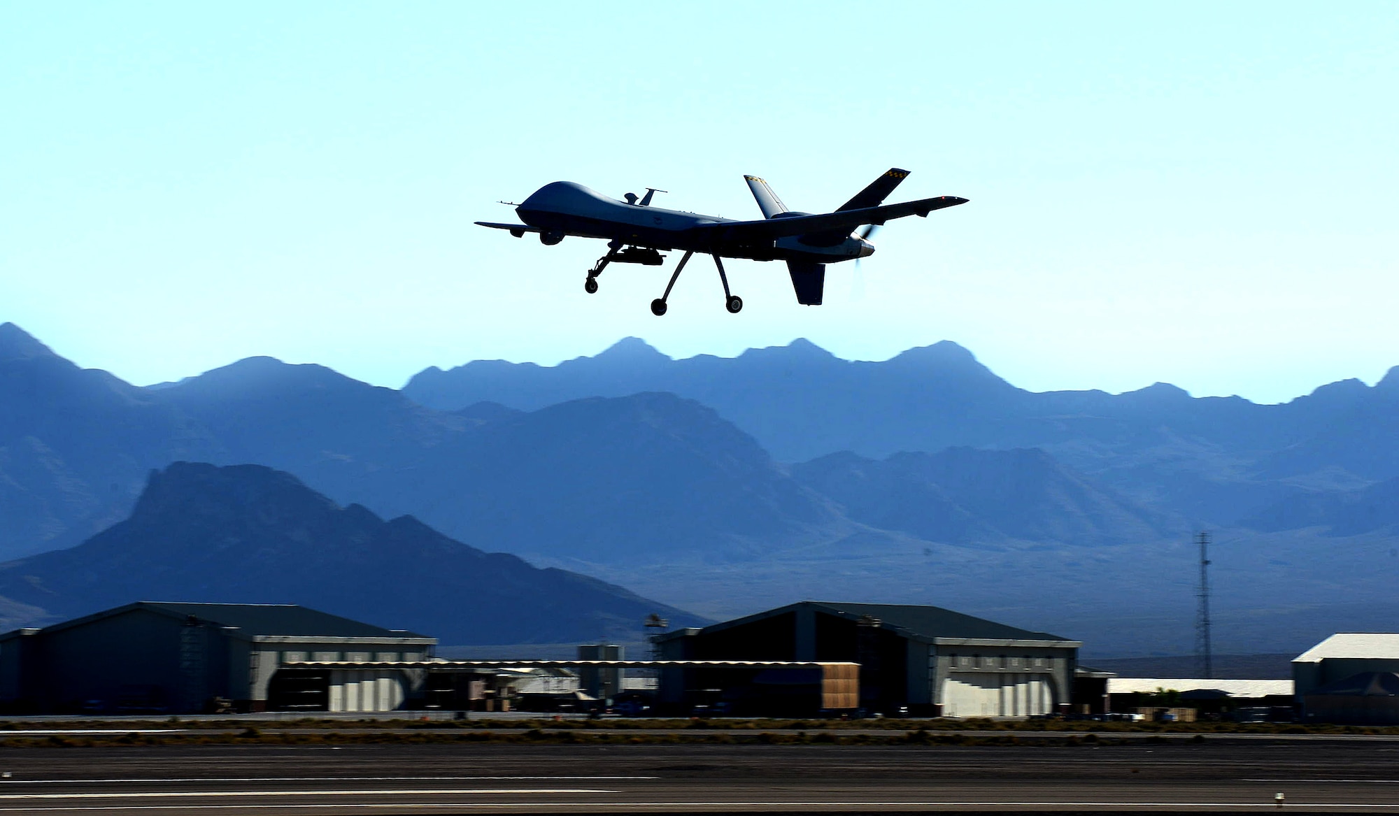 An MQ-9 Reaper performs touch-and-go flight patterns June 13, 2014, at Creech Air Force Base, Nev. The Reaper is an armed, multi-mission, medium-altitude, long-endurance remotely piloted aircraft that is employed primarily as an intelligence-collection asset and secondarily against dynamic execution targets. (U.S. Air Force photo/Senior Master Sgt. Cecilio Ricardo)