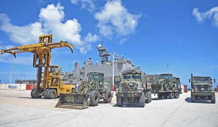 In this photo, Marines attached to the 31st Marine Expeditionary Unit (31st MEU) stage vehicles in front of the amphibious dock landing ship USS Ashland (LSD 48) during disaster relief efforts in Saipan after Typhoon Soudelor. The 31st MEU is embarked aboard the amphibious dock landing ship USS Ashland (LSD 48) and are on patrol in the U.S. 7th Fleet area of operations. 