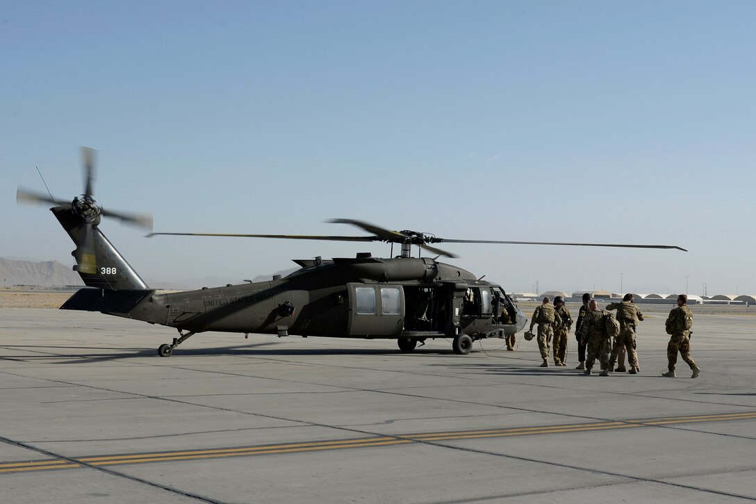 U.S. Army Brig. Gen. Paul Bontrager, commander of Train Advise Assist Command-South, Afghan army Brig. Gen. Dawood Shah Wafadar, commander of the 205th Corps, and staff members walk to a U.S. Army UH-60 Black Hawk helicopter at Kandahar Airfield, Afghanistan, Aug. 4, 2015, before an aerial battlefield familiarization flight.