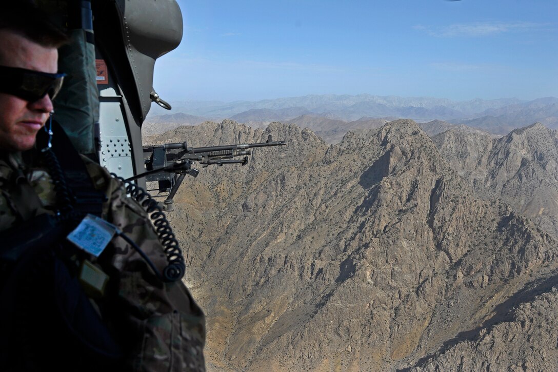 U.S. Army Command Sgt. Maj. Jody Volz, Afghan adviser for Train Advise Assist Command-South, rides in a U.S. Army UH-60 Black Hawk helicopter during an aerial battlefield familiarization flight over southern Afghanistan, Aug. 4, 2015.