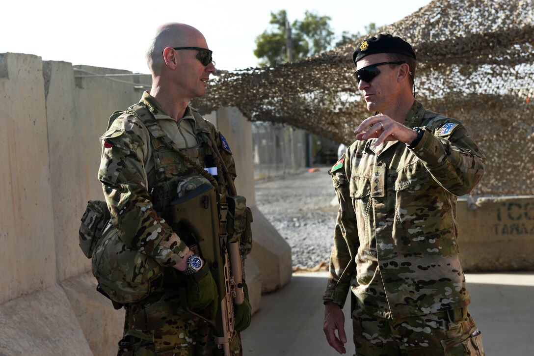 Australian army Col. Richard Mallet, left, deputy chief of staff for security force assistance, Train, Advise and Assist Command-South, and Australian army Col. Mitch Kent, commander of the Afghan army 205th Corps Advisory Team for TAAC-South, discuss their aerial battlefield familiarization flight plan at Kandahar Airfield, Afghanistan, Aug. 4, 2015.