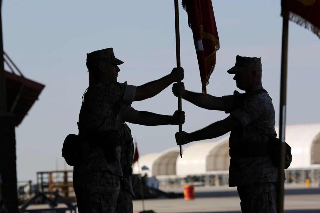 Outgoing Marine Fighter Attack Squadron 121 commanding officer, Lt. Col. Steve Gillette, receives the squadron colors for the last time before handing them over to the incoming commanding officer, Lt. Col. James Bardo, during the squadron's change of command ceremony aboard Marine Corps Air Station Yuma, Arizona, Friday, Aug. 14, 2015. The passing of the colors is the ceremony's most solemn moment, signifying the physical transfer of command from one Marine to the other.