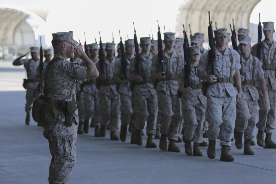 Marine Fighter Attack Squadron (VMFA) 121 commanding officer, Lt. Col. James Bardo, salutes his Marines during the pass-in-review portion of the squadron's change of command ceremony aboard Marine Corps Air Station Yuma, Arizona, Friday, Aug. 14, 2015. This will be Bardo’s first time commanding a squadron.